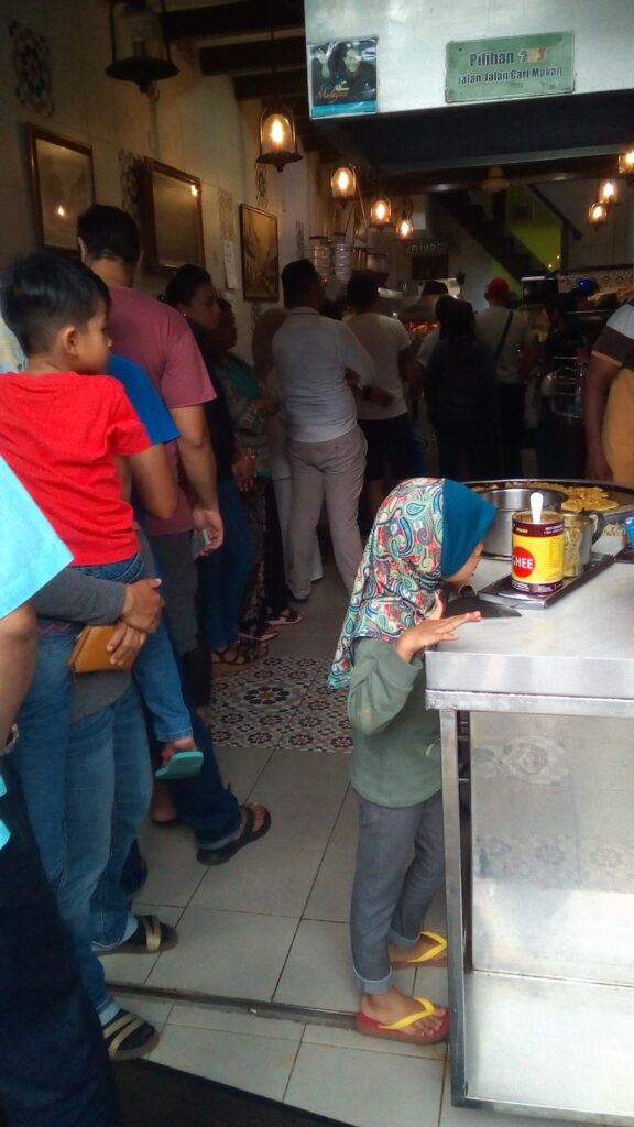 people lined up for food in Georgetown Malaysia